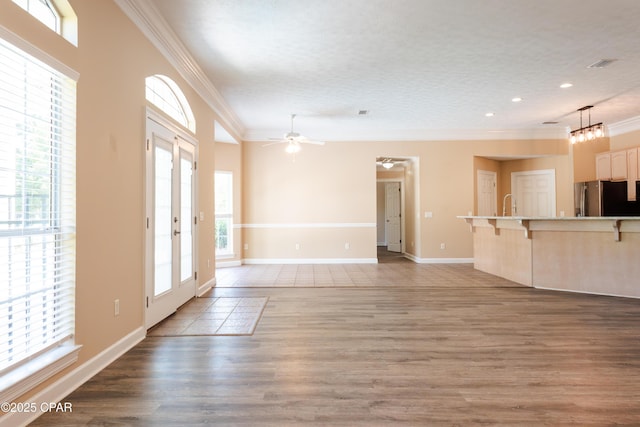 3522 Fox Run Blvd, Panama City, FL 32408 - unfurnished living room with recessed lighting, wood finished floors, visible vents, crown molding, and ceiling fan