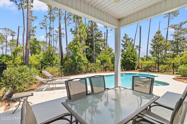 view of swimming pool featuring a fenced in pool, a patio, a fenced backyard, and outdoor dining space