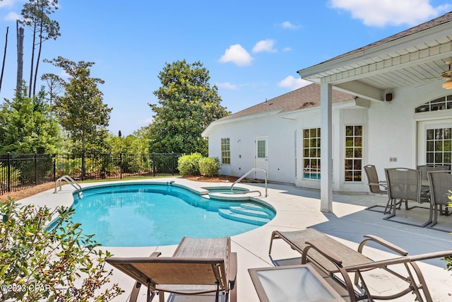 view of swimming pool with a patio, a fenced backyard, and a pool with connected hot tub