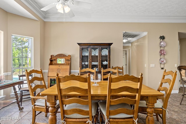 dining area with light tile patterned floors, baseboards, ceiling fan, and ornamental molding