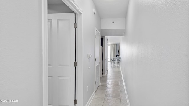 hall featuring light tile floors