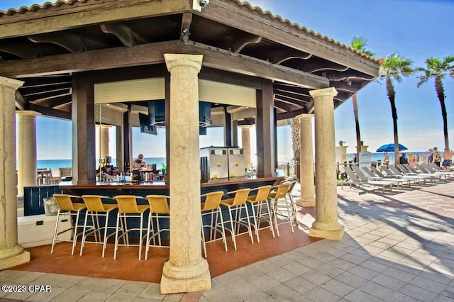 view of patio / terrace with a bar and a water view