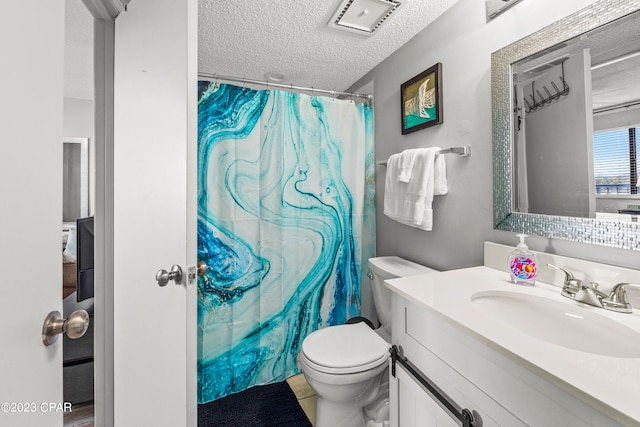 bathroom featuring tile patterned floors, vanity, a textured ceiling, toilet, and a shower with curtain