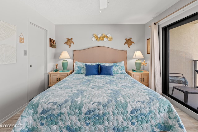 bedroom with light wood-type flooring, ceiling fan, and a textured ceiling