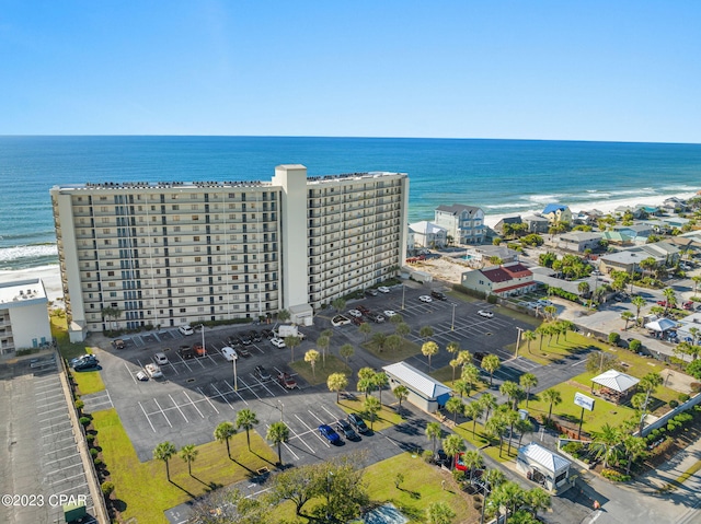 drone / aerial view featuring a water view and a beach view