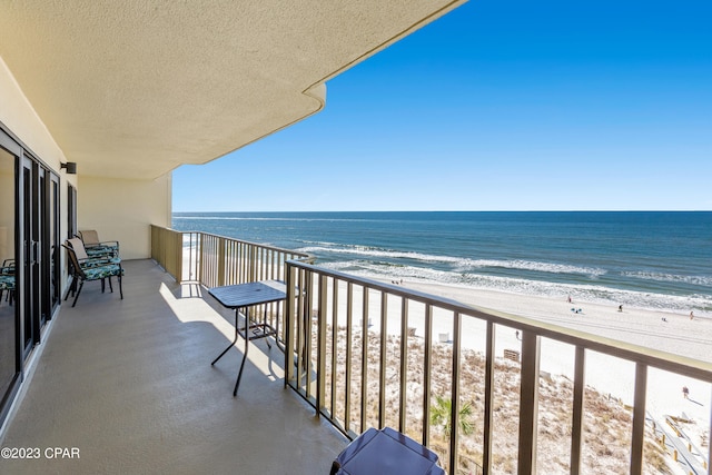 balcony with a view of the beach and a water view