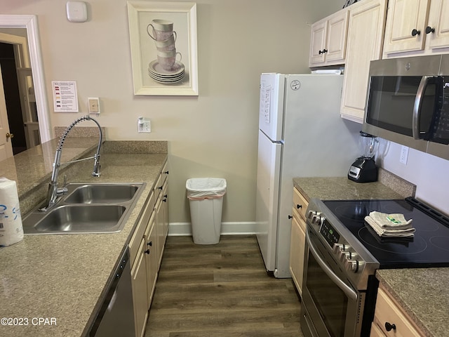 kitchen with stainless steel appliances, dark hardwood / wood-style floors, and sink