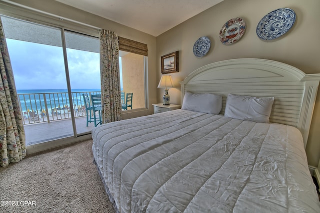 bedroom featuring access to exterior, light carpet, a water view, and lofted ceiling