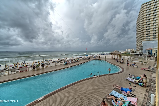 view of pool with a water view