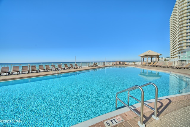 view of swimming pool with a water view