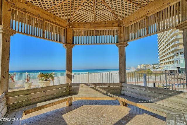 view of patio / terrace featuring a water view and a view of the beach