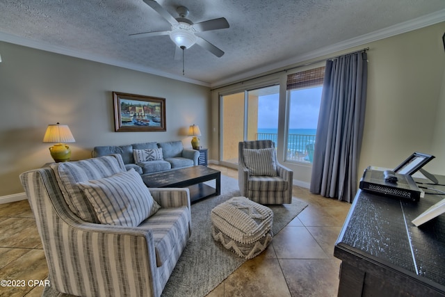 tiled living room with a textured ceiling, a water view, ceiling fan, and ornamental molding