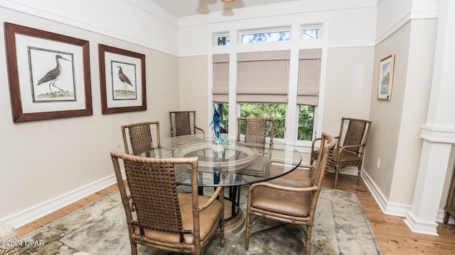 dining area with baseboards and wood finished floors