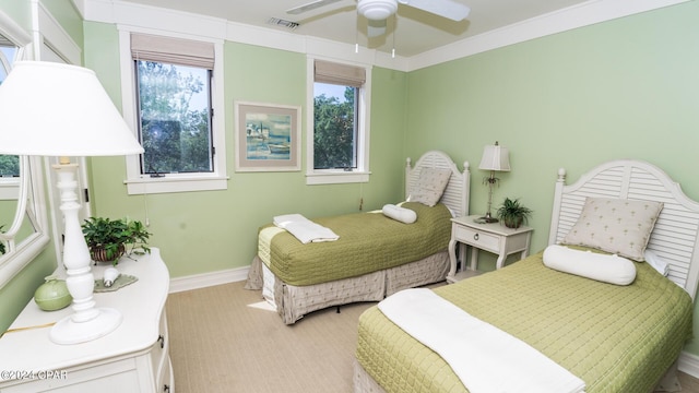 bedroom with baseboards, visible vents, light colored carpet, and ceiling fan