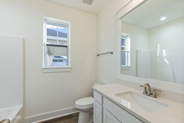 bathroom featuring hardwood / wood-style flooring, vanity, and toilet