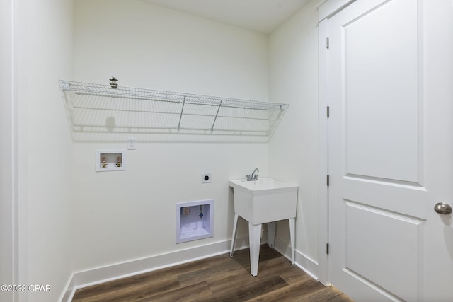 clothes washing area with electric dryer hookup, hookup for a washing machine, and dark hardwood / wood-style floors