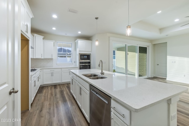 kitchen with white cabinetry, sink, stainless steel appliances, backsplash, and pendant lighting