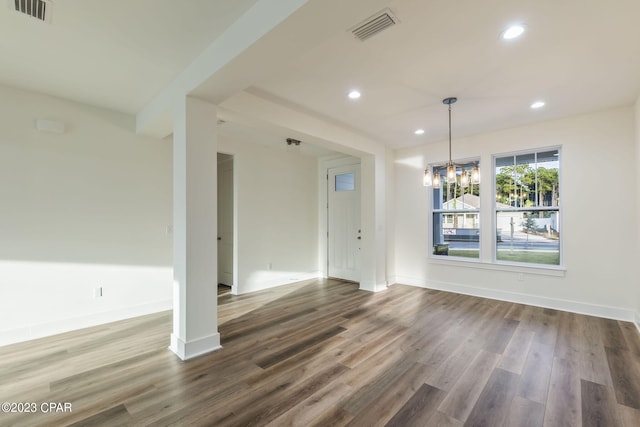 interior space with dark hardwood / wood-style flooring and an inviting chandelier