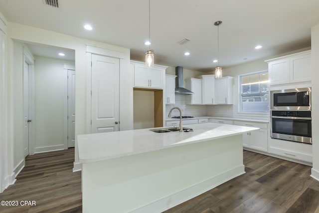 kitchen featuring white cabinetry, an island with sink, and appliances with stainless steel finishes