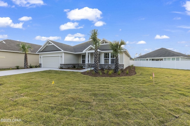 view of front of property featuring a front yard and a garage