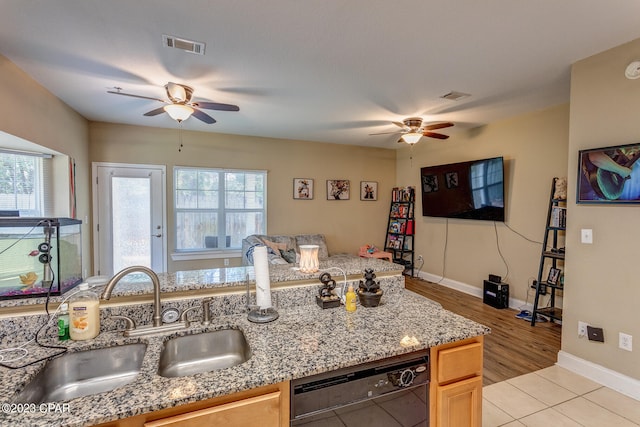 kitchen featuring light tile floors, dishwasher, ceiling fan, and sink