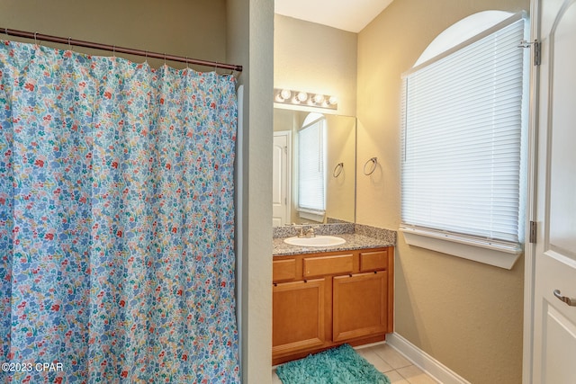 bathroom with tile floors and vanity