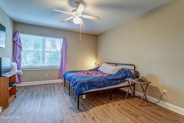 bedroom with ceiling fan and light hardwood / wood-style flooring