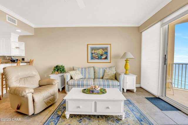 living room with crown molding and light tile patterned floors