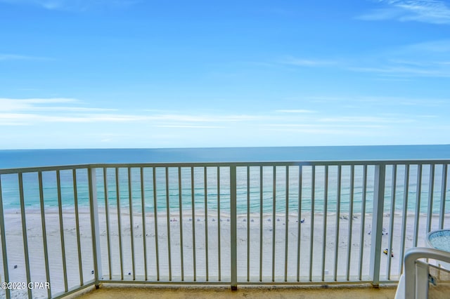 balcony with a water view and a beach view