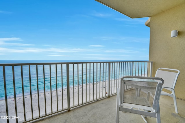 balcony with a water view and a beach view