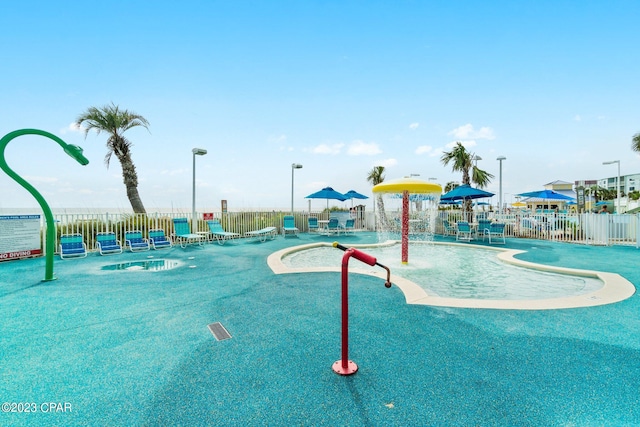 view of swimming pool with pool water feature