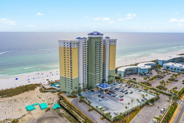 birds eye view of property featuring a beach view and a water view