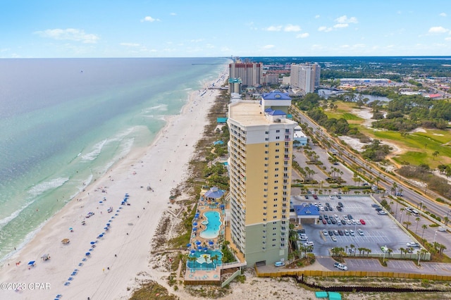 birds eye view of property with a water view and a beach view