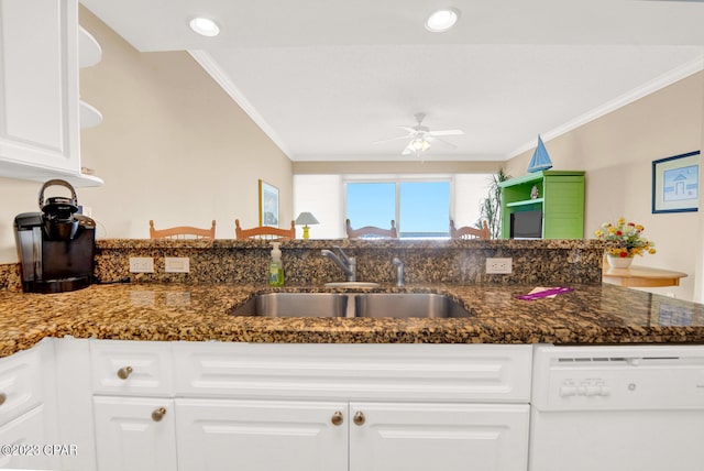 kitchen with dishwasher, white cabinets, sink, crown molding, and dark stone countertops