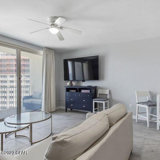 living room featuring ceiling fan and light tile floors