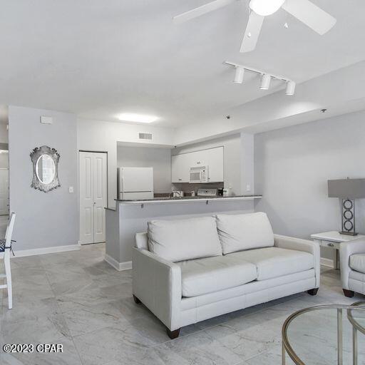 living room featuring ceiling fan, light tile floors, and track lighting