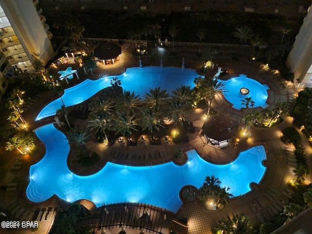 view of pool at twilight