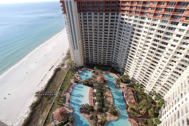 birds eye view of property with a water view and a view of the beach