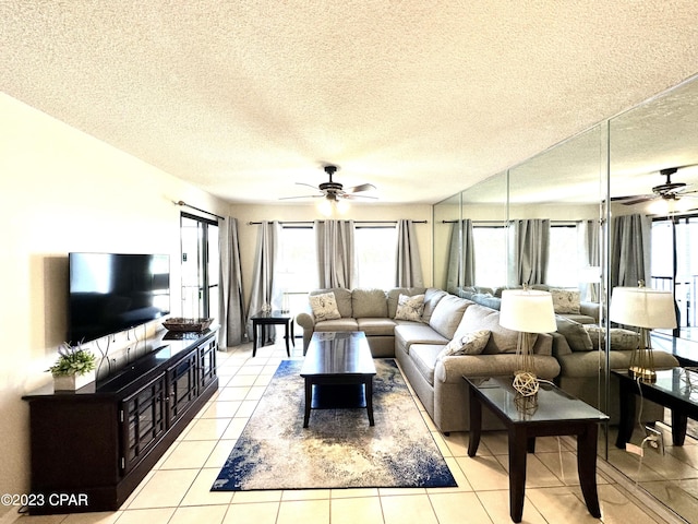 tiled living room featuring ceiling fan and a textured ceiling