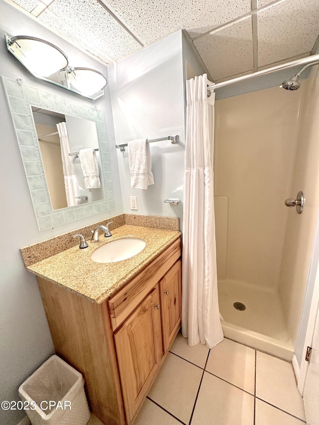 bathroom featuring a drop ceiling, tile floors, vanity, and a shower with curtain