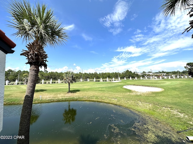 view of home's community featuring a water view and a yard