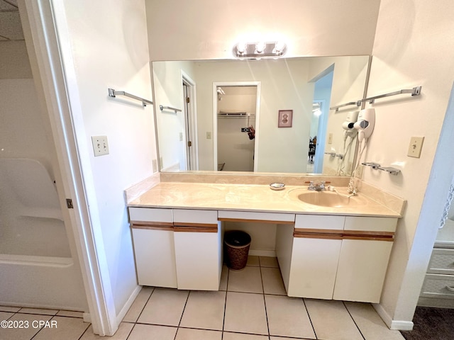 bathroom with tile floors and vanity