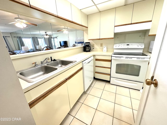 kitchen featuring light tile flooring, ceiling fan, white appliances, and sink