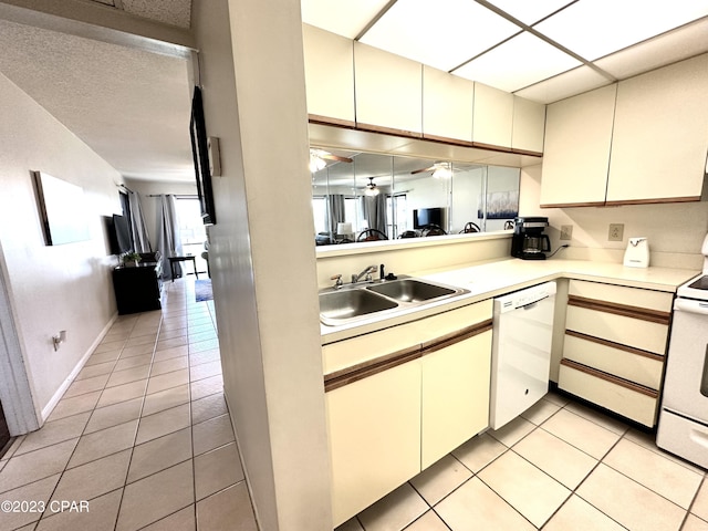 kitchen with white appliances, ceiling fan, sink, and light tile flooring