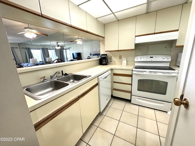 kitchen featuring ceiling fan, white appliances, sink, light tile floors, and cream cabinetry