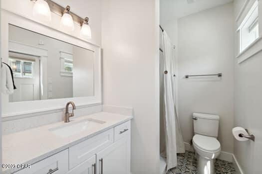 bedroom with connected bathroom, ceiling fan, and light wood-type flooring