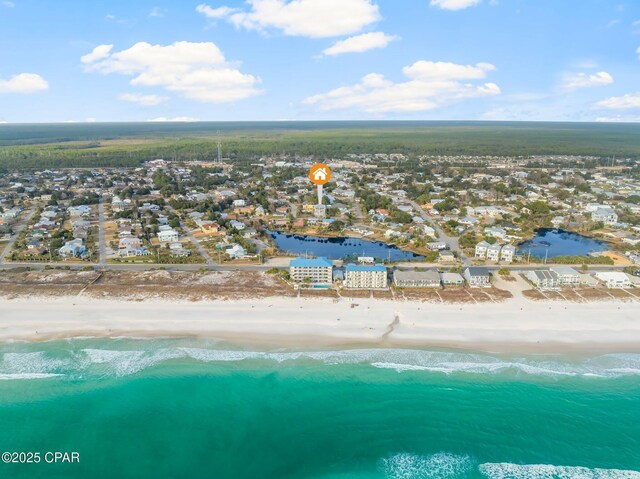 birds eye view of property with a water view and a view of the beach