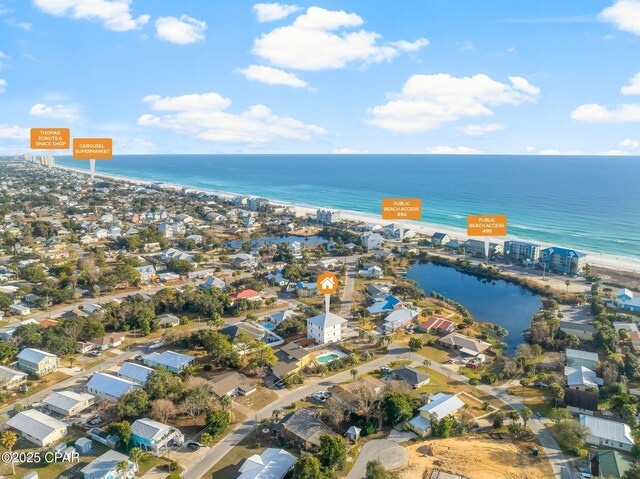 aerial view featuring a water view and a beach view