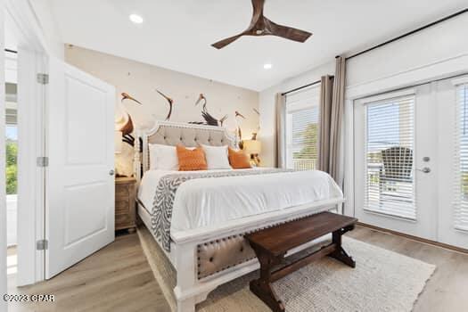 bedroom featuring ceiling fan, access to exterior, and light hardwood / wood-style floors