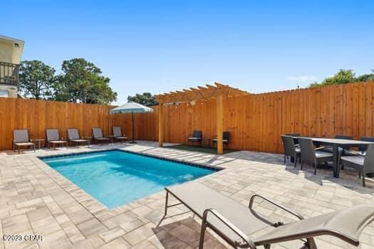 view of pool with a pergola and a patio